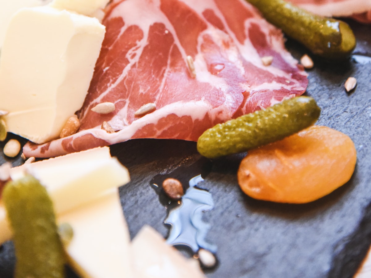 Charcuterie basket with cured meats, aged cheeses, olives, and crackers