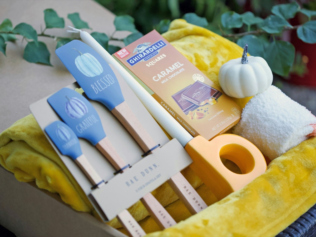 Welcome Home gift box with kitchen utensils, chocolate, and a soft throw blanket